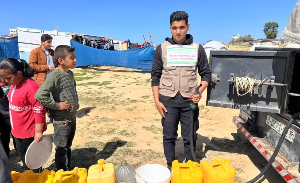 A Muslim Family Aid volunteer at a water distribution point in Gaza