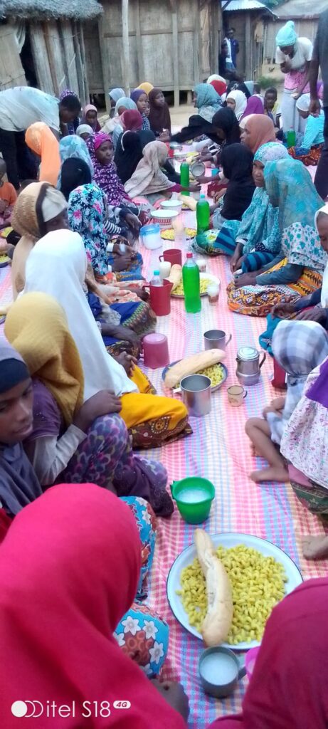 Families sharing a meal together at a community iftar